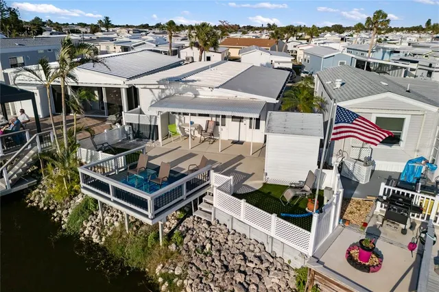 an aerial view of residential houses with outdoor space and swimming pool