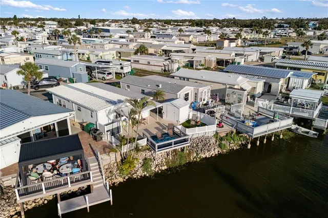 an aerial view of residential houses with outdoor space and swimming pool