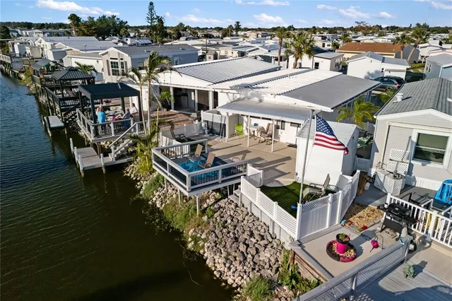 an aerial view of a house with a yard and lake view