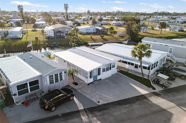 an aerial view of residential houses with outdoor space and swimming pool
