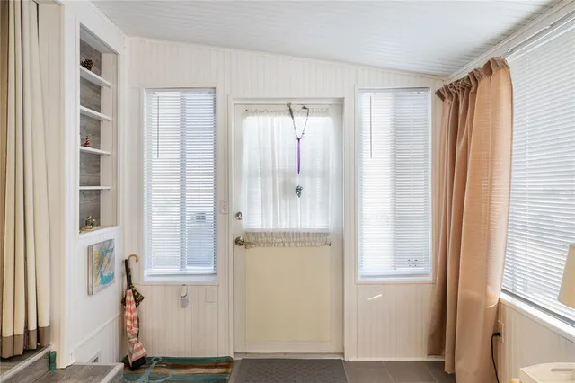 a view of a hallway with wooden floor and workspace