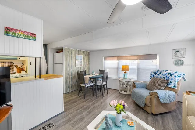 a living room with furniture and kitchen view