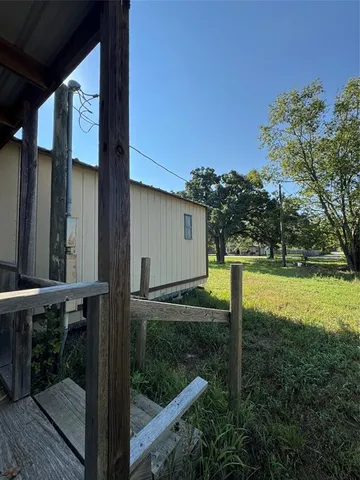 a view of backyard with small cabin