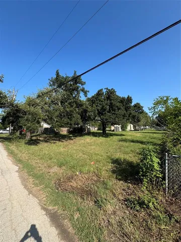 a view of a field of grass and trees