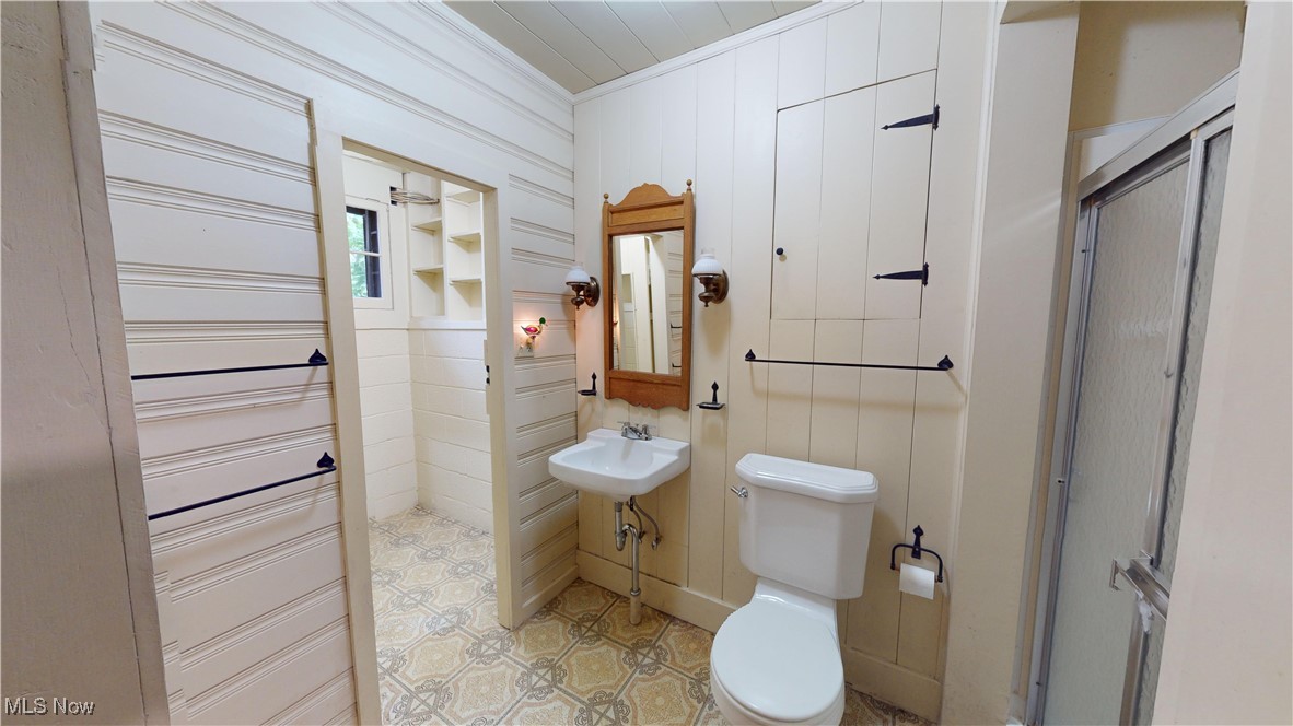 13696 Sperry Road Novelty, OH 44072 - Photo 9 of 40 Bathroom featuring an enclosed shower, toilet, tile patterned floors, sink, and ornamental molding