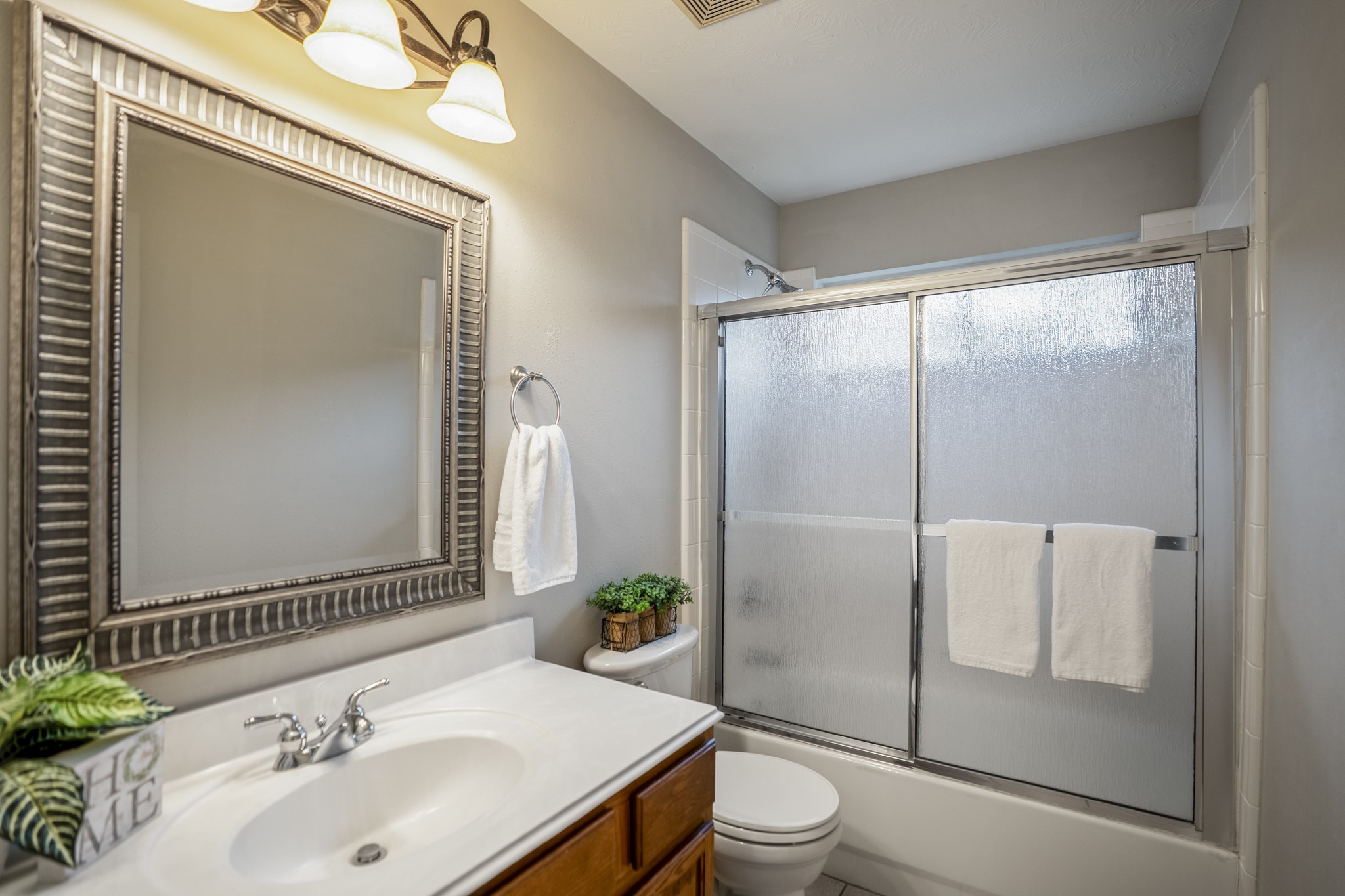 6311 Sparrows Glen Lane Spring, TX 77379 - Photo 28 of 50 Located off the upstairs hall, the full bath serves the secondary bedrooms with a tub/shower combination, framed mirror, and neutral finishes that keep the space clean, functional, and easy to maintain.