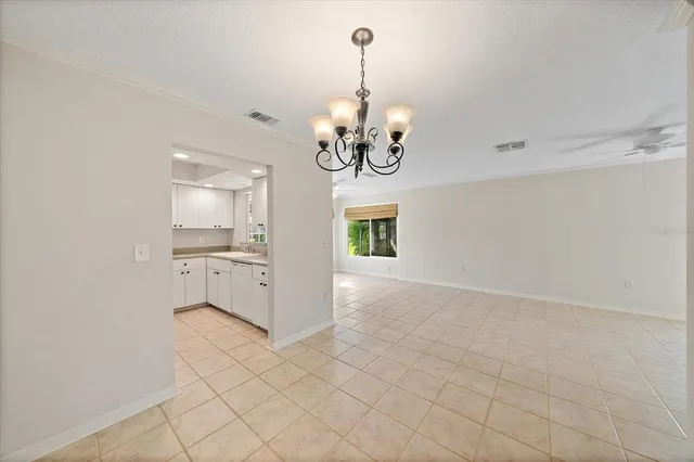 a view of a kitchen with granite countertop cabinets and a chandelier