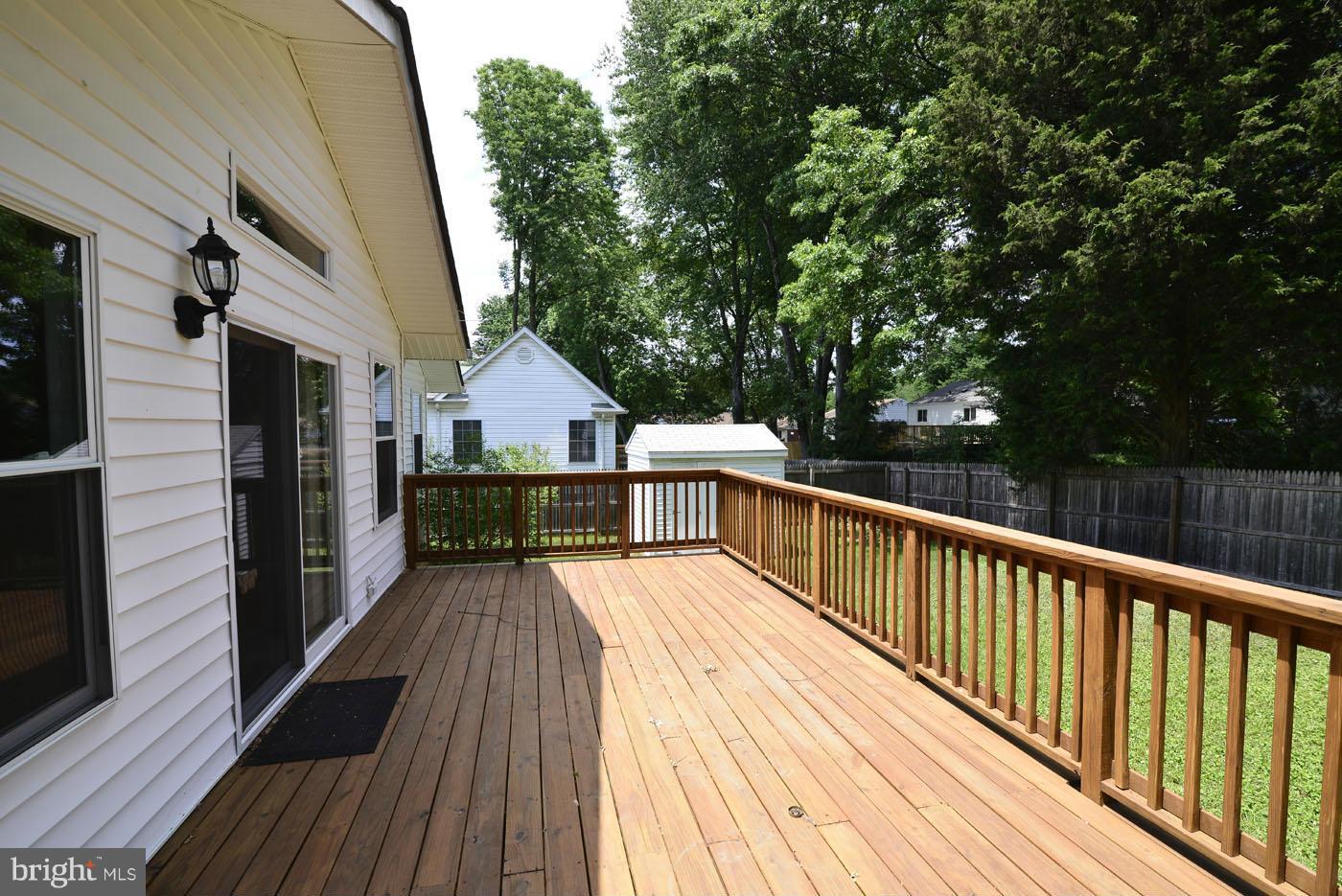 7115 Kerr Drive Springfield, VA 22150 - Photo 3 of 25 a view of deck with wooden floor and fence next to a yard