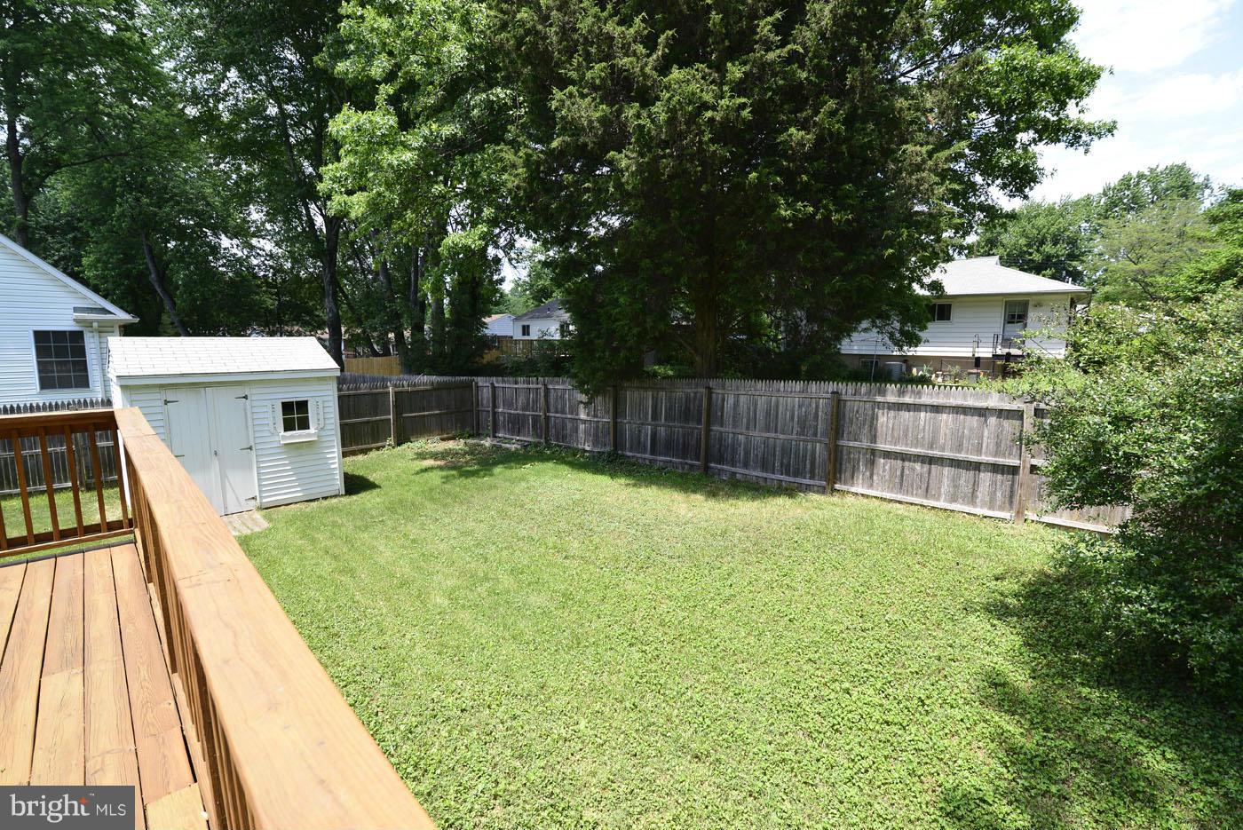 7115 Kerr Drive Springfield, VA 22150 - Photo 24 of 25 a view of a backyard with a large tree and wooden fence