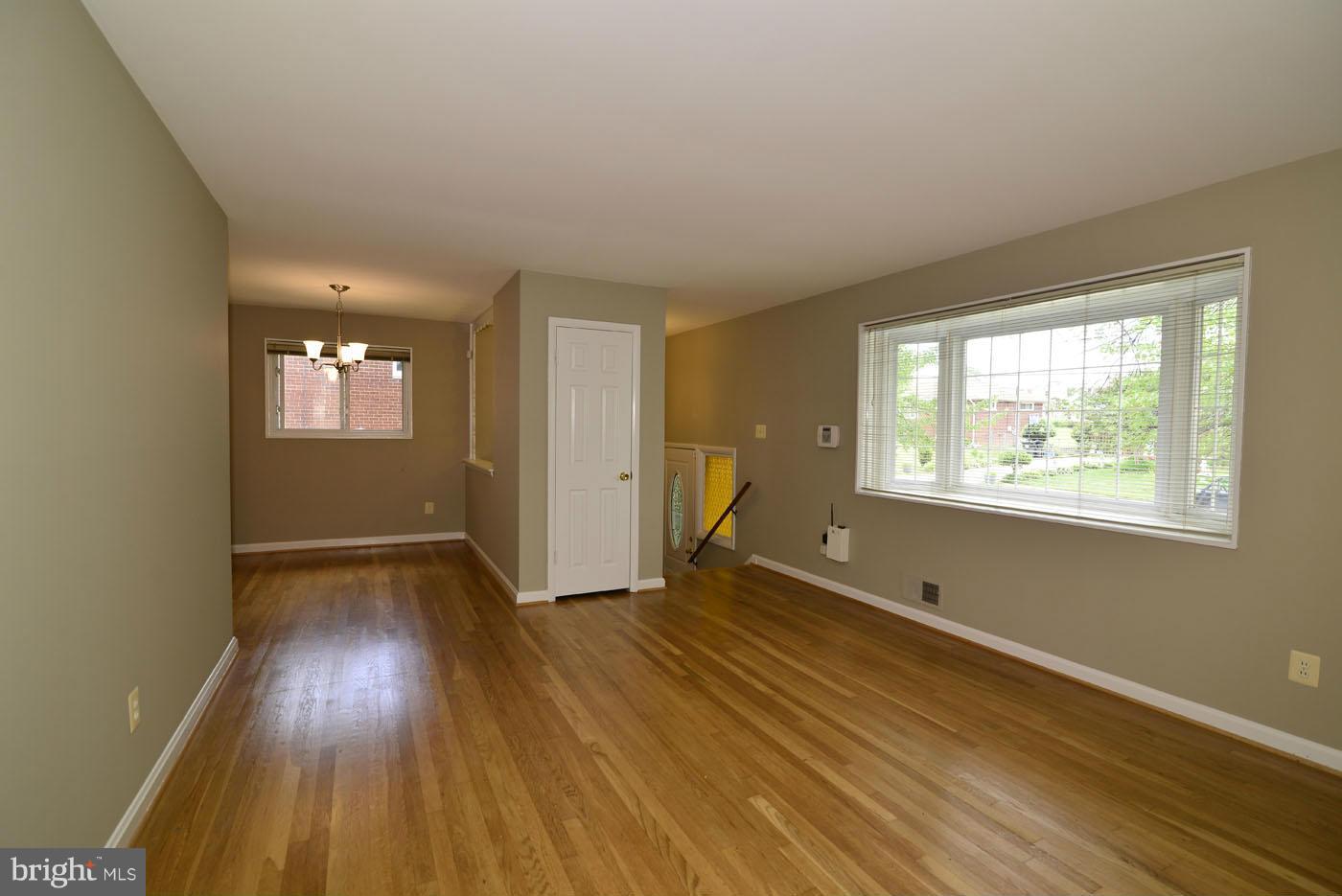 7115 Kerr Drive Springfield, VA 22150 - Photo 5 of 25 an empty room with wooden floor and windows