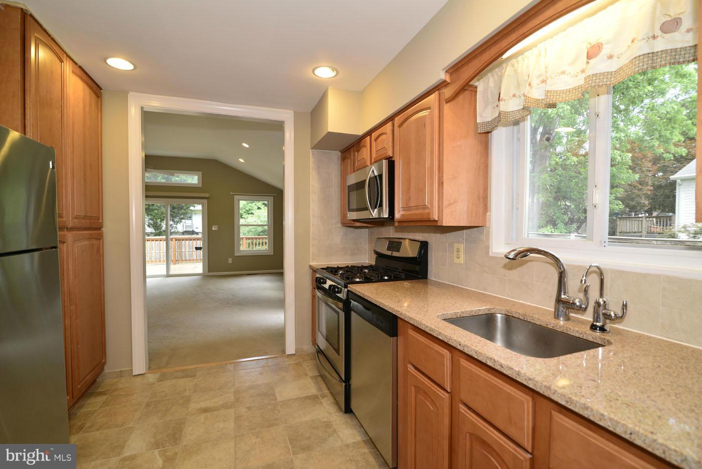 7115 Kerr Drive Springfield, VA 22150 - Photo 8 of 25 a kitchen with stainless steel appliances granite countertop a sink a refrigerator and a sink