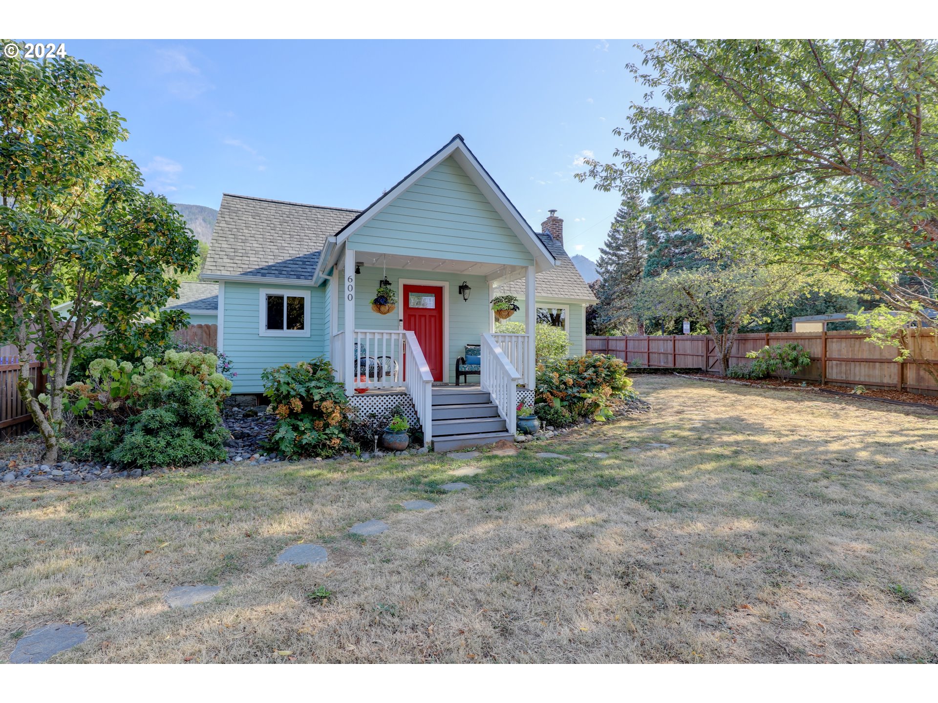 600 Forest Lane Cascade Locks, OR 97014 - Photo 2 of 48 a view of a house with a yard and potted plants