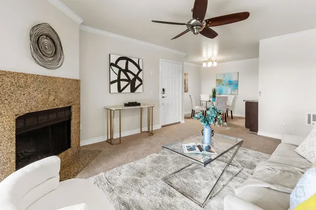 a living room with furniture and a fireplace