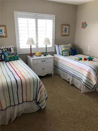 a bedroom with bed and a window