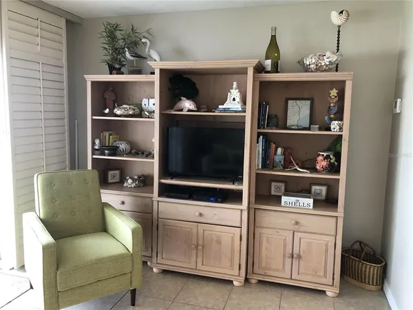 a living room with furniture cabinets and window