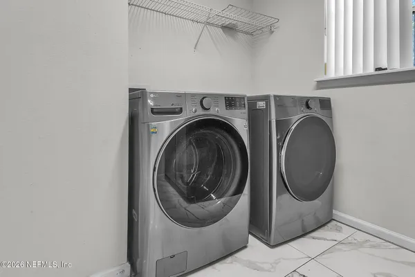 a utility room with dryer and washer