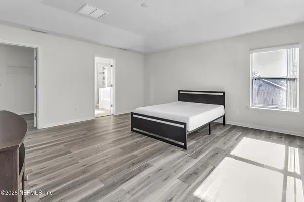 a bedroom with a bed and window