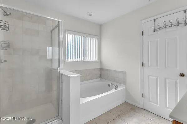 a white bath tub sitting next to a shower