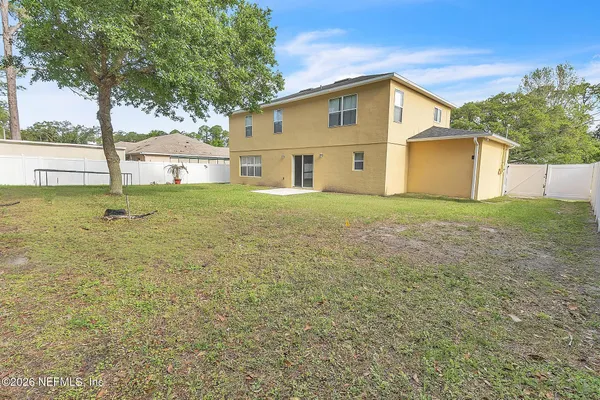 a big house with large trees and a big yard