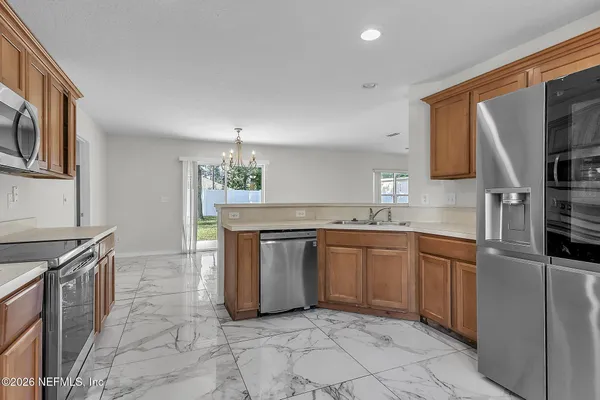 a kitchen with granite countertop a sink and a stove top oven