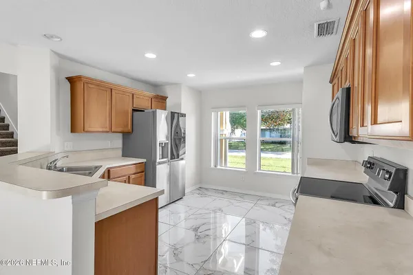 a spacious bathroom with a tub sink and mirror