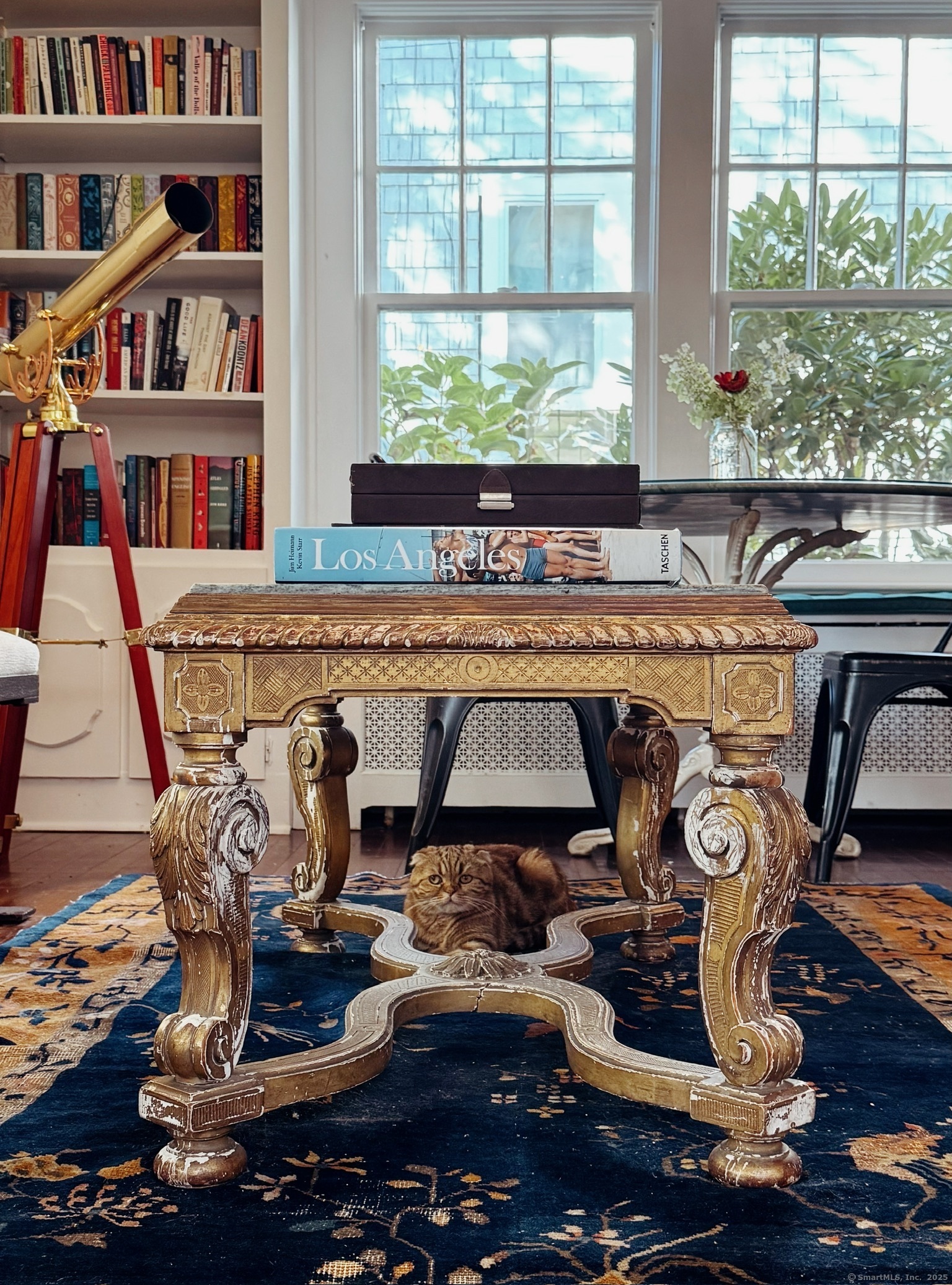 89 Richmond Hill Road New Canaan, CT 06840 - Photo 12 of 17 a living room with lots of furniture and a book shelf