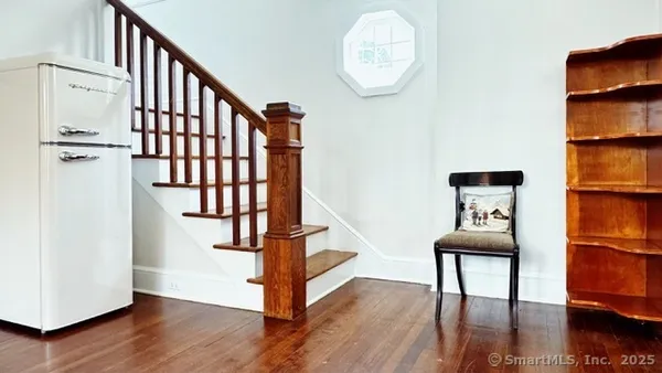 a view of a hallway with wooden floor and workspace