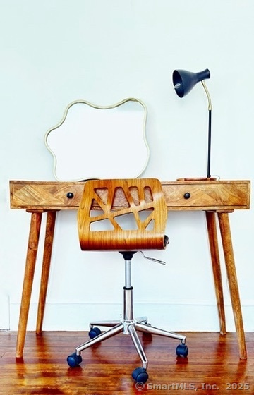 89 Richmond Hill Road New Canaan, CT 06840 - Photo 17 of 17 a living room with a table and a flat screen tv