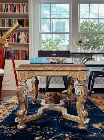 a living room with lots of furniture and a book shelf