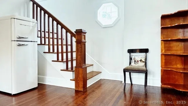 a view of a hallway with wooden floor and workspace