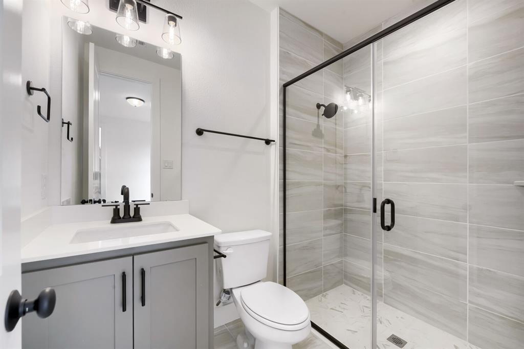 733 Red Cedar Road Haslet, TX 76052 - Photo 21 of 28 Bathroom featuring a glass-enclosed shower with tiled walls and a tiled floor