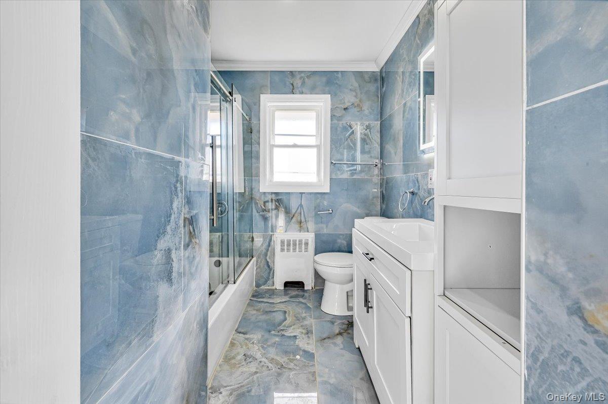 95 Harold Avenue Hempstead, NY 11550 - Photo 13 of 29 a bathroom with a sink a toilet and shower