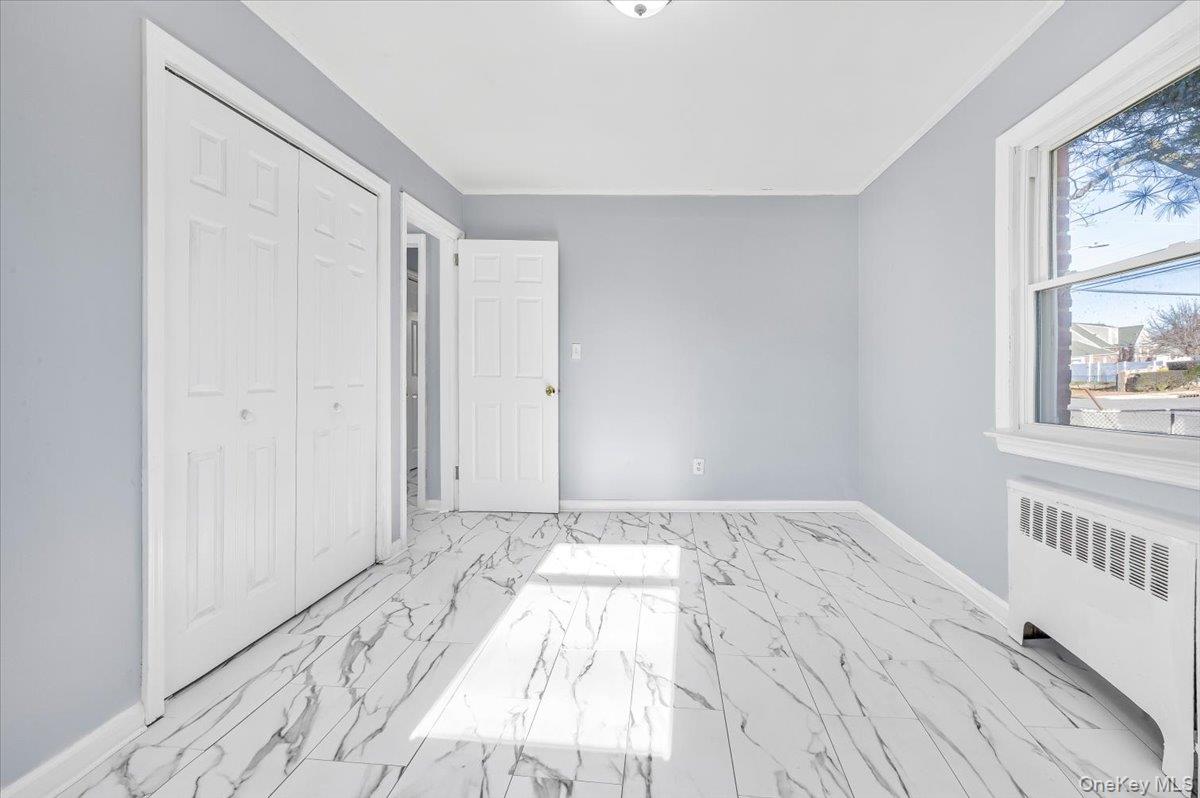 95 Harold Avenue Hempstead, NY 11550 - Photo 15 of 29 a view of a bedroom with wooden floor and windows
