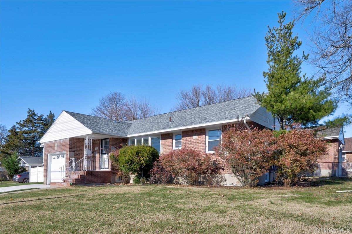 95 Harold Avenue Hempstead, NY 11550 - Photo 2 of 29 front view of a house with a yard