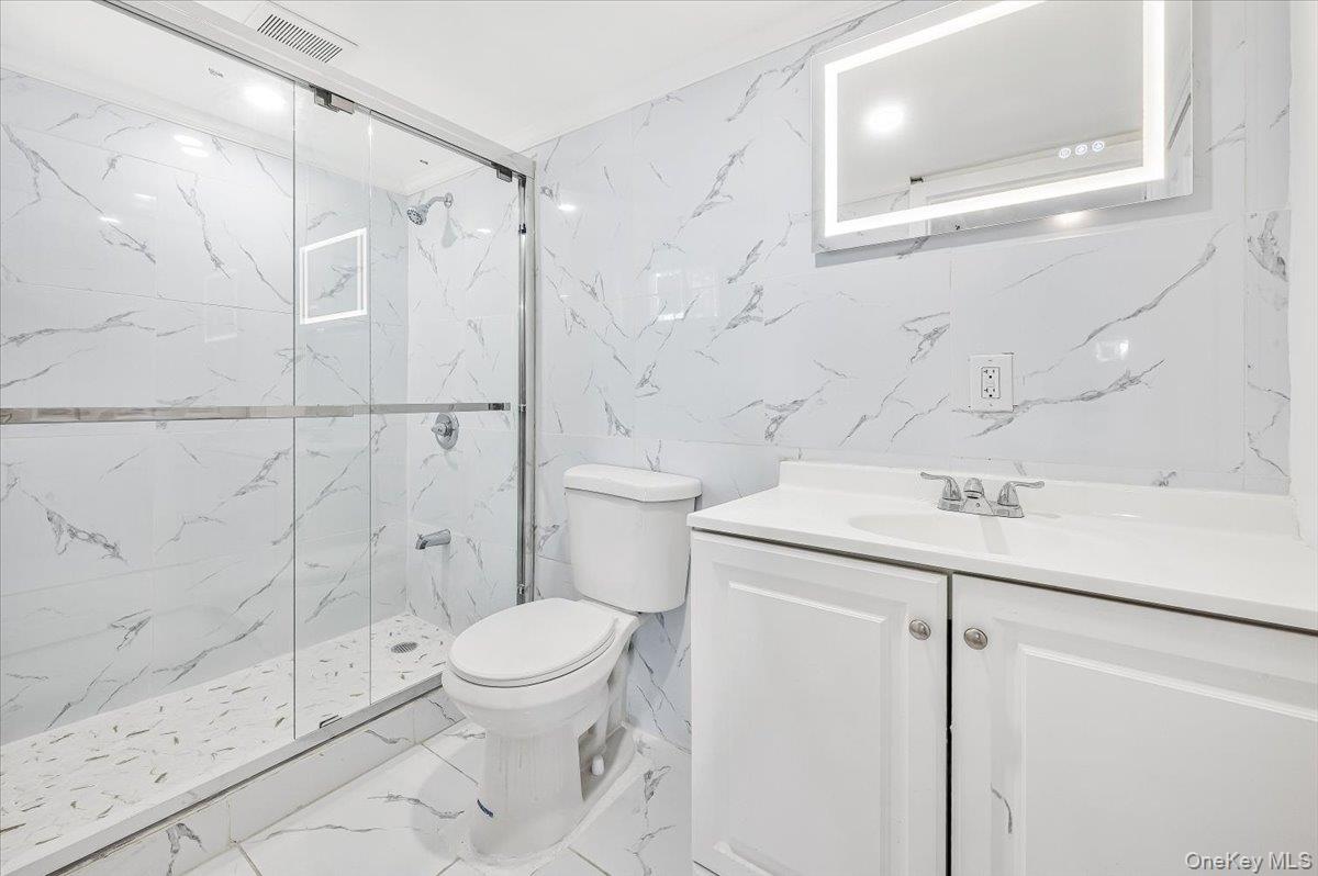 95 Harold Avenue Hempstead, NY 11550 - Photo 22 of 29 a bathroom with a granite countertop sink toilet and shower