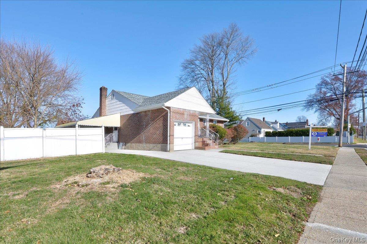 95 Harold Avenue Hempstead, NY 11550 - Photo 25 of 29 a view of a house with a yard and garage