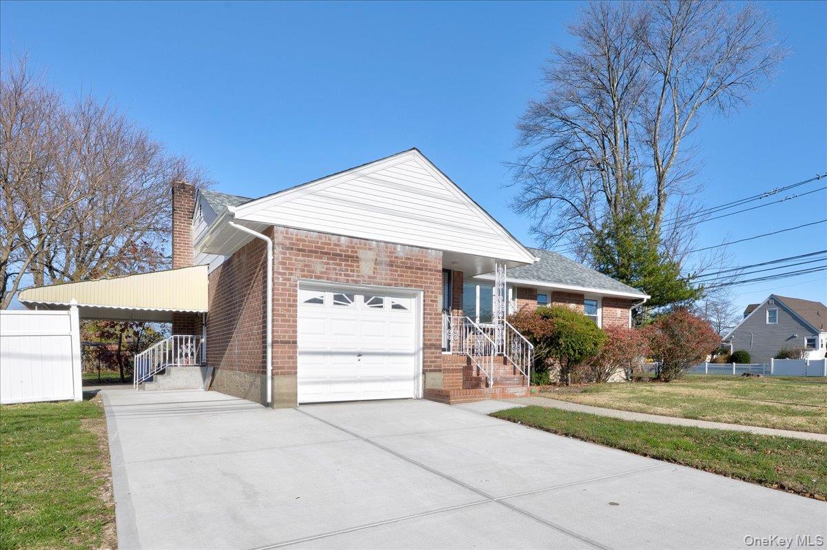 95 Harold Avenue Hempstead, NY 11550 - Photo 3 of 29 a view of a house with a yard and garage