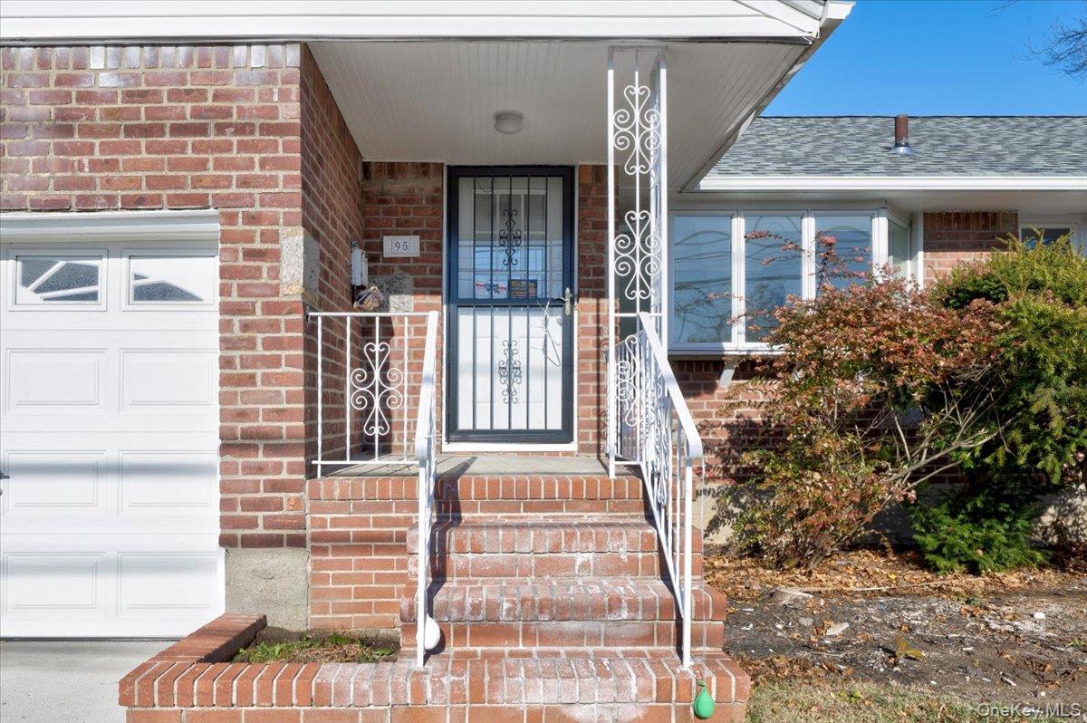 95 Harold Avenue Hempstead, NY 11550 - Photo 4 of 29 a front view of a house with a garden