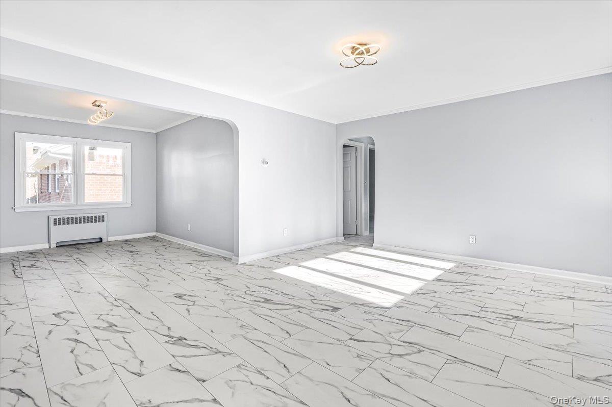 95 Harold Avenue Hempstead, NY 11550 - Photo 6 of 29 a view of empty room with window and wooden floor