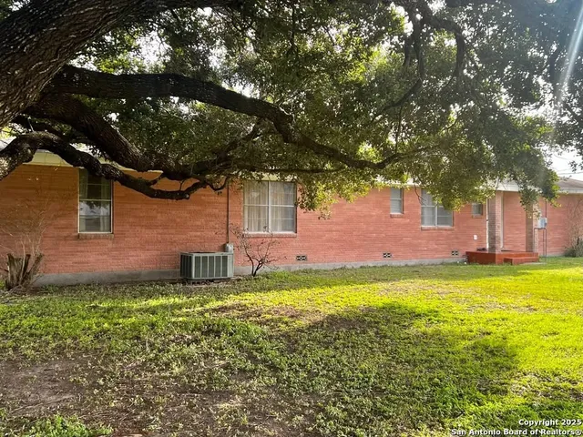 a backyard of a house with yard and outdoor seating