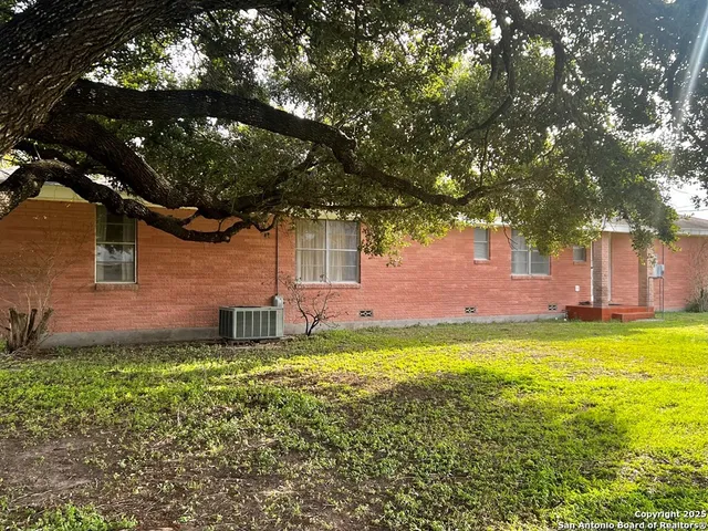 a backyard of a house with yard and outdoor seating