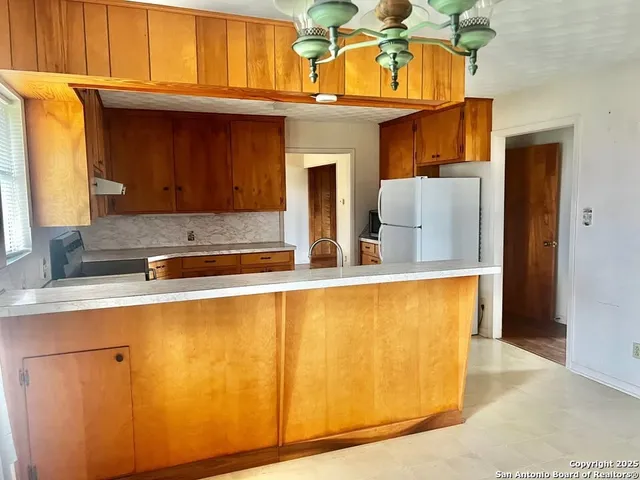 a view of a kitchen with a sink and cabinets
