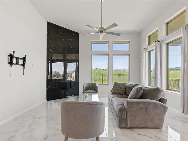 a living room with furniture and kitchen view