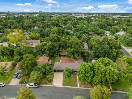an aerial view of a house with a yard