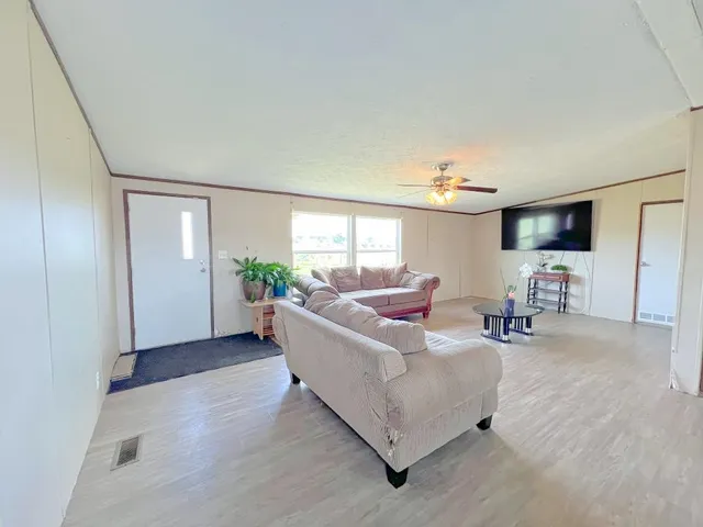 a living room with furniture and wooden floor