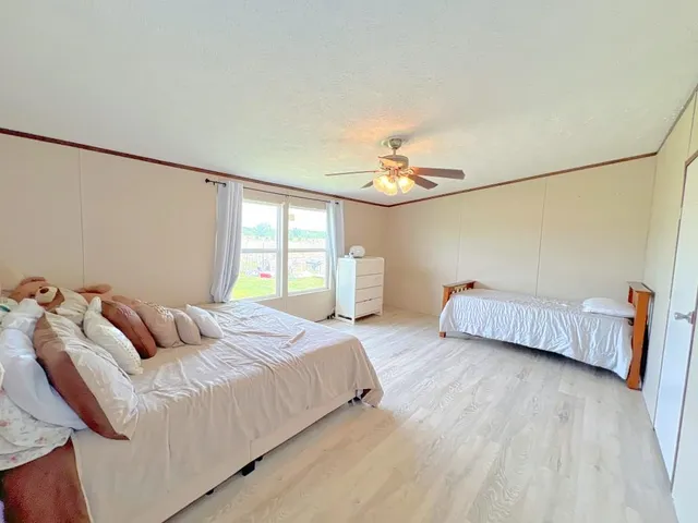a bedroom with a bed and a chandelier