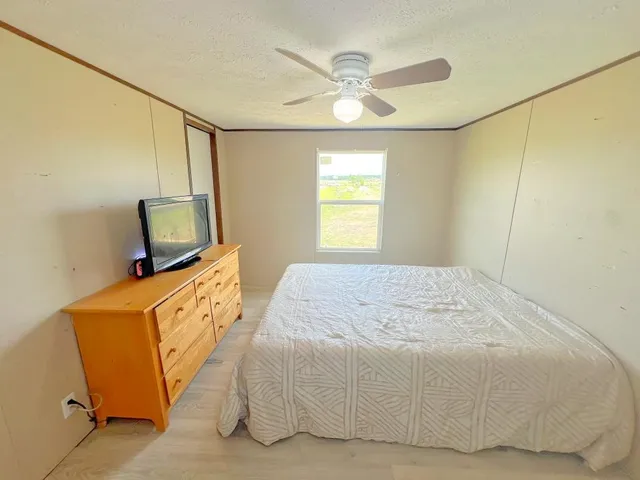 a bed sitting in a bedroom next to a window