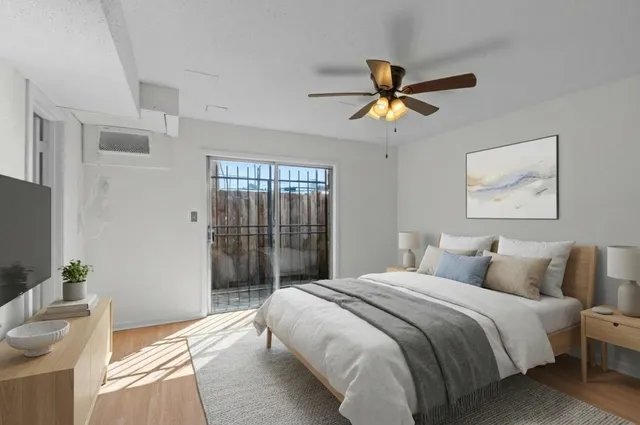 a bedroom with a bed and a chandelier