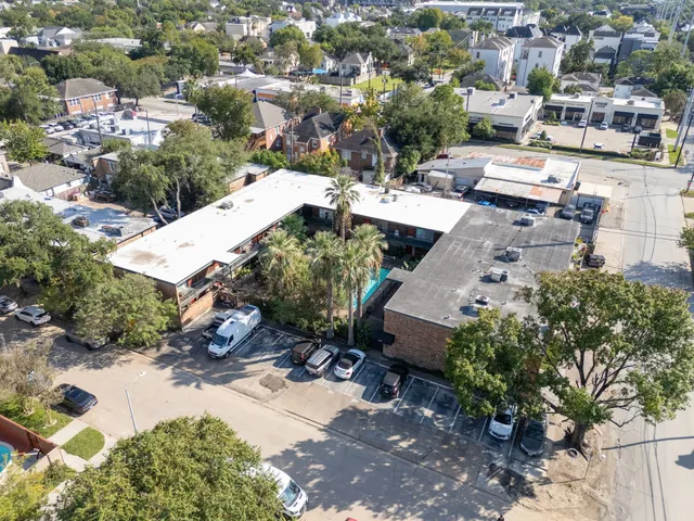 an aerial view of a house with a yard basket ball court and outdoor seating