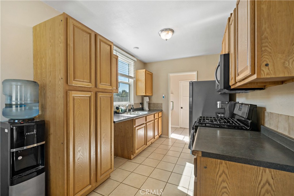 6006 Colonial Drive Riverside, CA 92506 - Photo 11 of 36 a kitchen with stainless steel appliances granite countertop a refrigerator a stove and a sink